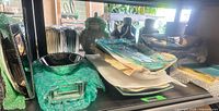 Shelf with assorted trays, bowls and platters, some bubble-wrapped