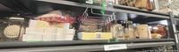 Shelf with perfumes, candle, glass decor, boxed items, towel, chrome tray