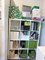 Full view of shelving unit with assorted office storage items