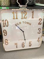 Front view showing entire square clock, numerals, frame and handle