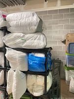 Stack of pillow inserts on shelving unit