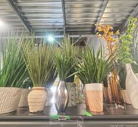Group shot showing all artificial grasses and varied vases on shelf