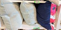 Shelf view showing all three pillows together