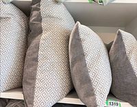 Close-up of pillow faces showing geometric Kravet Kyra fabric