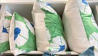 Four cushions on shelf showing both square and rectangular shapes