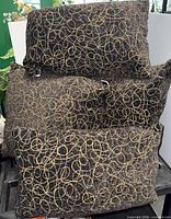 All four pillows stacked showing pattern and shapes