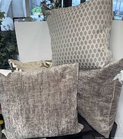 Group shot of all four pillows showing front textures and patterns