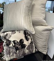 Stack of all five pillows showing both designs