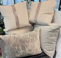 Group of five pillows arranged together showing colors and textures
