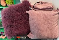 Shaggy faux fur pillow and textured pillow with additional covers