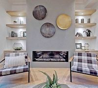 Lifestyle view showing three of the metal discs displayed over fireplace
