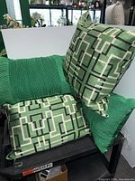 Group view of geometric and ribbed stripe pillows stacked