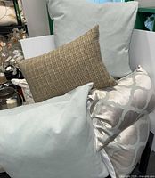 Assorted pillows stacked showing colors and patterns