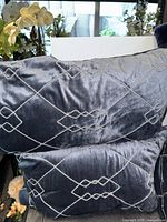 Stacked view of two rectangular embroidered pillows