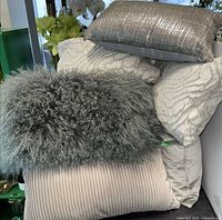 Stacked view of assorted decorative pillows