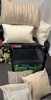 Stack of three rectangular pillows on shelf, showing pleated beige, plain cream and plain ivory designs