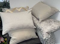 group of assorted pillows stacked showing variety of designs