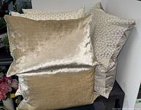 Front view showing gold velvet ribbed pillows and taupe geometric pillow