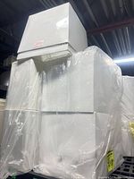 stack of four white rectangular lamp shades wrapped in plastic