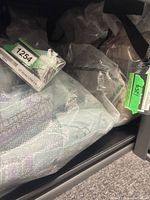 Packaged bedding sets in clear plastic bags on shelf