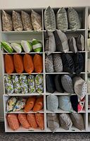 Front view of three white shelving units filled with pillows