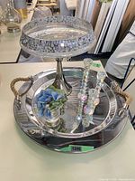 Entire lot showing trays, pedestal bowl, candle holders, faux flowers
