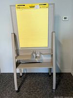 Front view showing tackable side with Post-it pad and marker tray