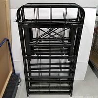 Front view of folded black metal twin platform bed frame
