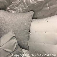 Close-up of Silver Grey Dot duvet fabric and accent pillows