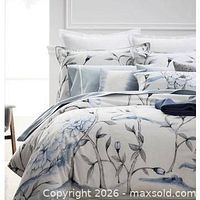 Blue/grey floral Hotel Collection bedding set staged on bed
