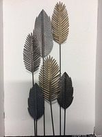 Front view of metal leaf sculpture showing six leaves