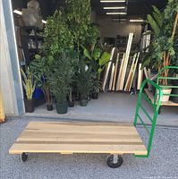 Full view of Uline wood platform truck in front of warehouse