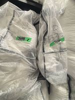 Bagged bedskirt and shams labelled Q