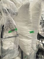 Set sealed in clear plastic, showing white quilted pieces