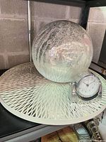 Orb on lattice tray with clock