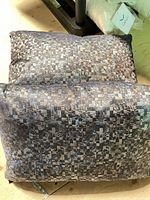 Two grey patterned pillows stacked