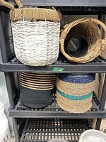 Top shelf white wicker basket and natural wicker basket with planter inside