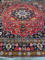 Full view of Mashhad Persian rug showing entire pattern and borders