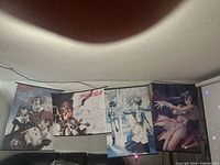 Overview of five anime wall scrolls hanging on wall