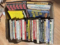 Top-down view of box showing roughly two rows of vintage paperbacks