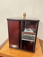 Three-quarter view of tower showing CD slots with cases inserted