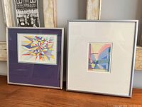 Both framed watercolour paintings side by side