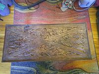 Full view of carved rectangular coffee table top showing overall design