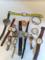 Full group shot showing all thirteen wristwatches