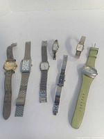 Seven watches laid out side-by-side