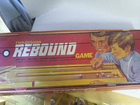 Box top showing Two-Cushion Rebound Game branding and illustration