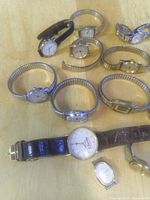 Group of Timex wristwatches showing mixed metal finishes, straps and expansion bands