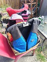 Box containing four life jackets showing colors and stack