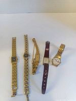 Group shot of all five watches laid out