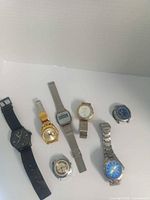 Group shot of all seven watches laid out on white background